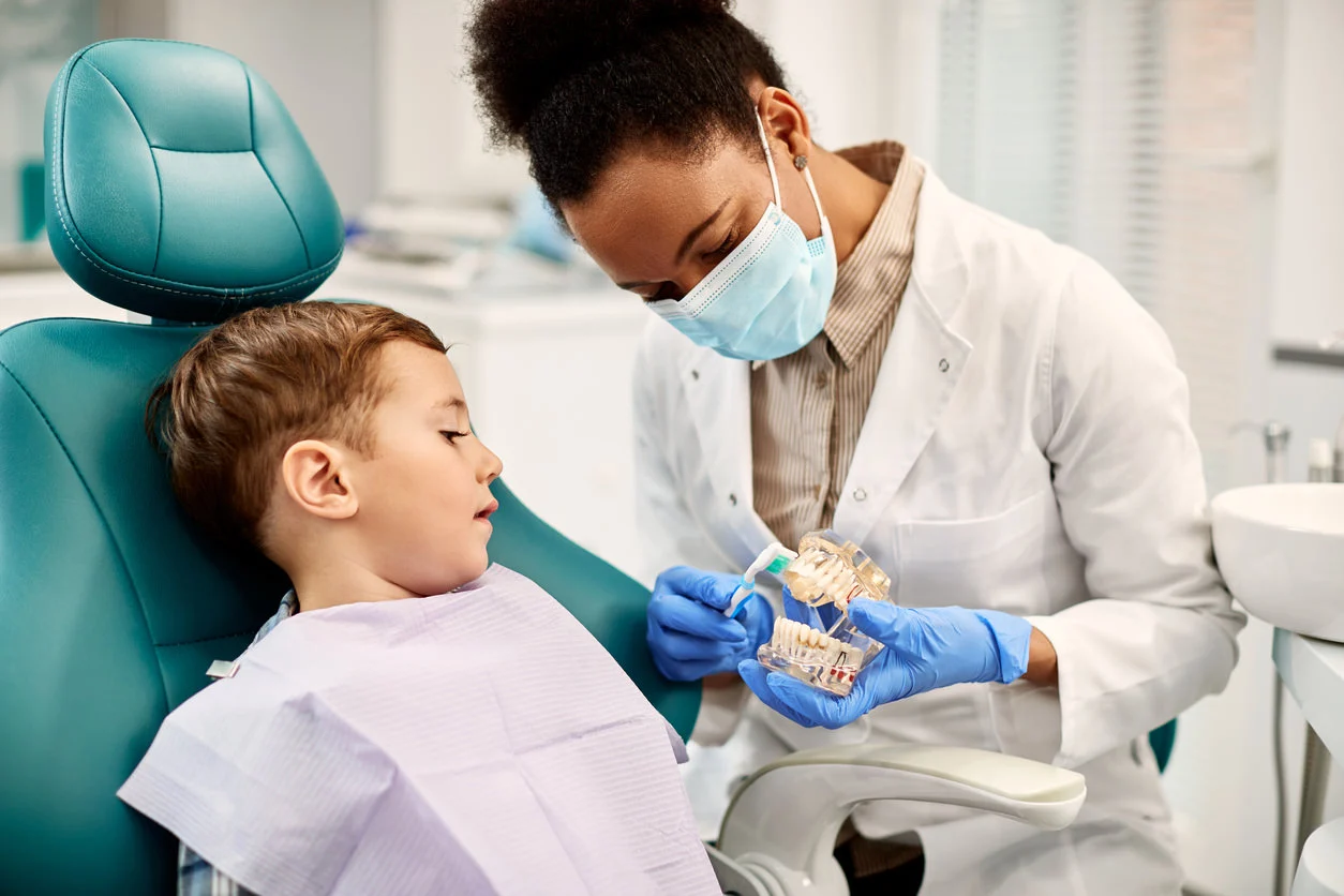 Dentists with patient discussing care. 
