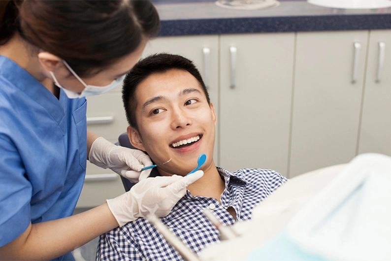 AAPI female dentist caring for patient
